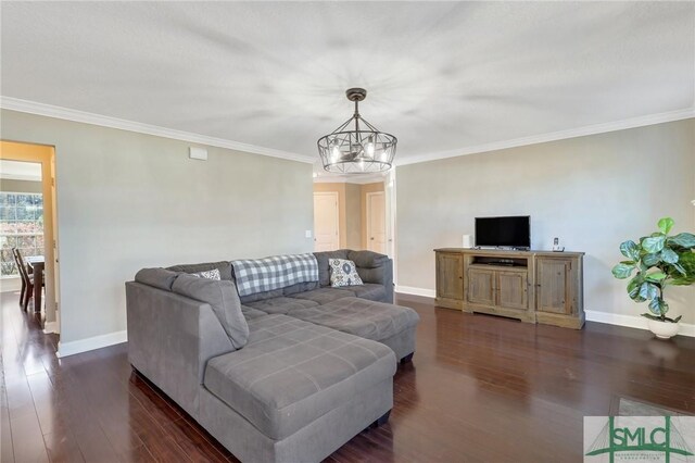 469 Nashview Trl, Allenhurst, GA 31301 - living room featuring dark wood-style floors, ornamental molding, baseboards, and an inviting chandelier