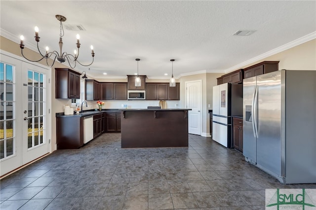 469 Nashview Trl, Allenhurst, GA 31301 - kitchen featuring stainless steel appliances, a sink, french doors, a center island, and decorative light fixtures