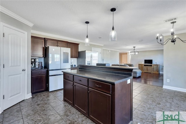 469 Nashview Trl, Allenhurst, GA 31301 - kitchen featuring dark countertops, stainless steel fridge, freestanding refrigerator, and a center island
