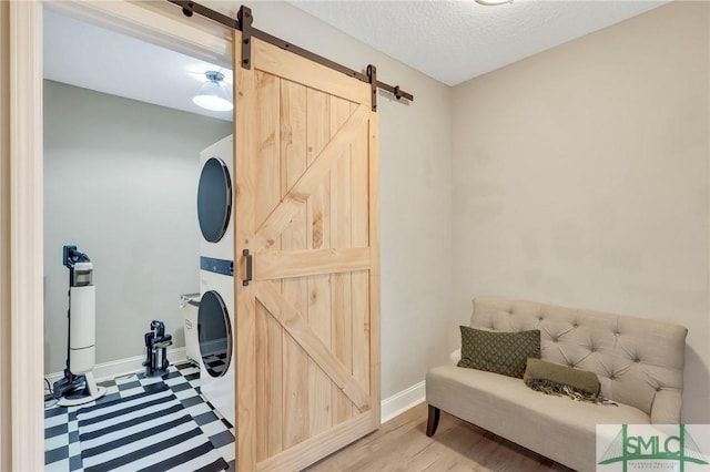 469 Nashview Trl, Allenhurst, GA 31301 - interior space featuring a textured ceiling, stacked washer and dryer, a barn door, and baseboards