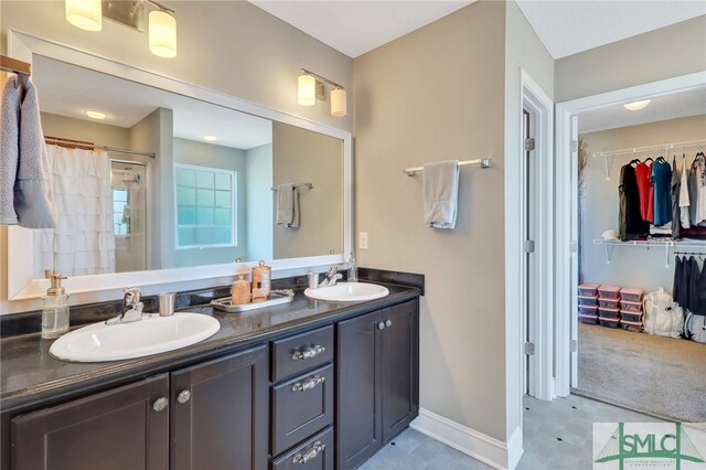 469 Nashview Trl, Allenhurst, GA 31301 - full bath with double vanity, a stall shower, a walk in closet, and a sink