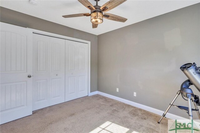 469 Nashview Trl, Allenhurst, GA 31301 - unfurnished bedroom featuring baseboards, ceiling fan, a closet, and light colored carpet