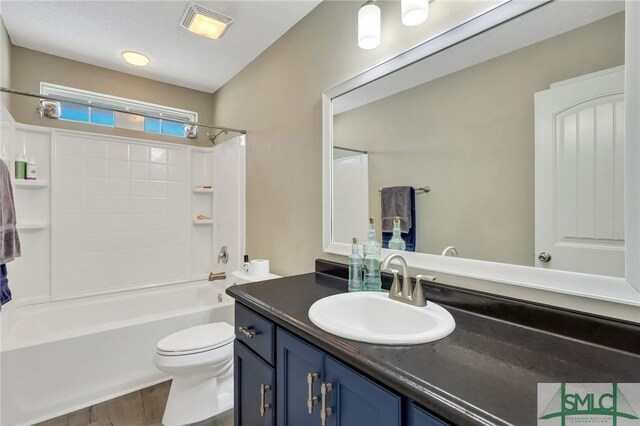469 Nashview Trl, Allenhurst, GA 31301 - bathroom with visible vents, toilet, vanity, shower / tub combination, and wood finished floors
