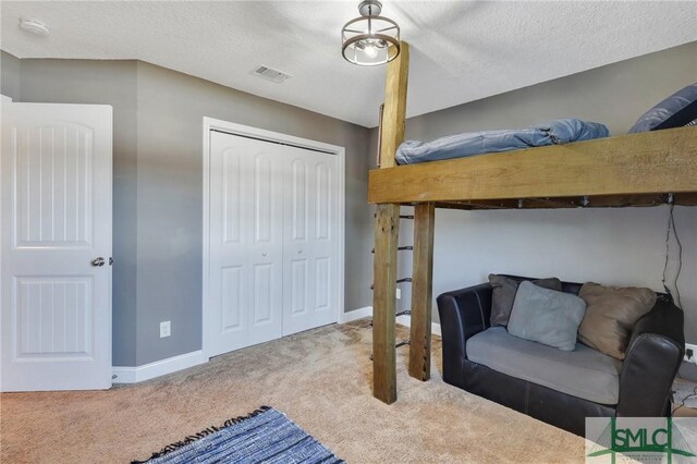469 Nashview Trl, Allenhurst, GA 31301 - carpeted bedroom with a closet, visible vents, a textured ceiling, and baseboards