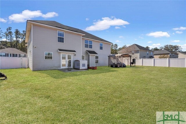 469 Nashview Trl, Allenhurst, GA 31301 - rear view of property with a fenced backyard, a residential view, and a lawn