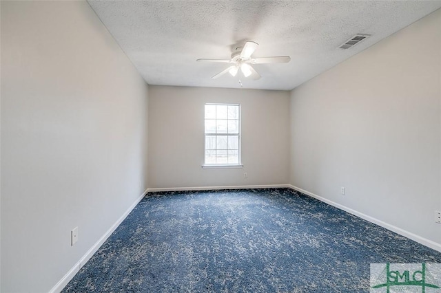 empty room featuring a textured ceiling, carpet flooring, visible vents, baseboards, and a ceiling fan