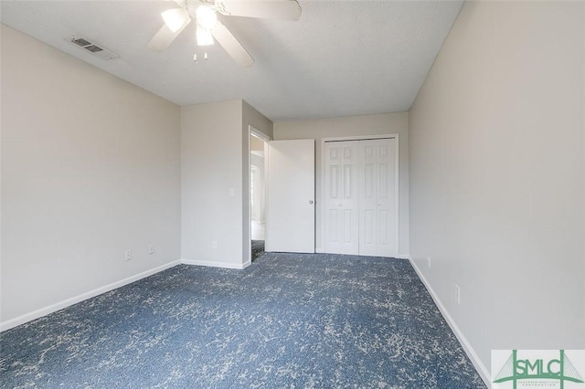 unfurnished bedroom with baseboards, a closet, visible vents, and a ceiling fan