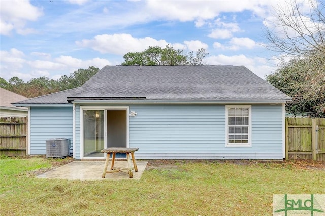 rear view of property with a patio, a lawn, and fence