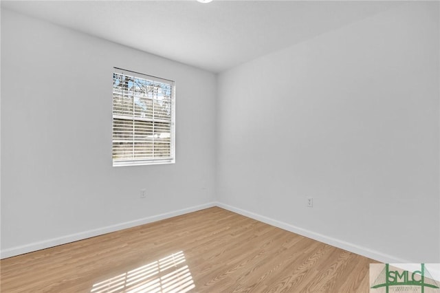 unfurnished room featuring light wood-type flooring and baseboards