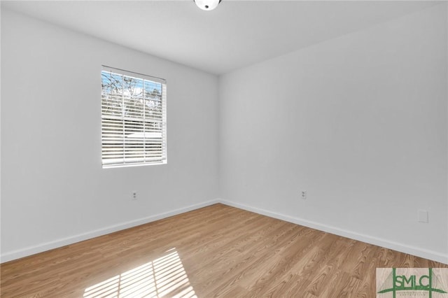 unfurnished room featuring light wood finished floors and baseboards