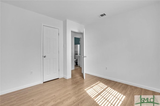 unfurnished bedroom featuring light wood-type flooring, visible vents, and baseboards