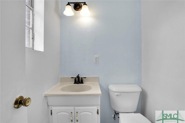 bathroom featuring toilet and vanity