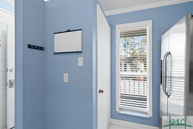 doorway to outside with ornamental molding