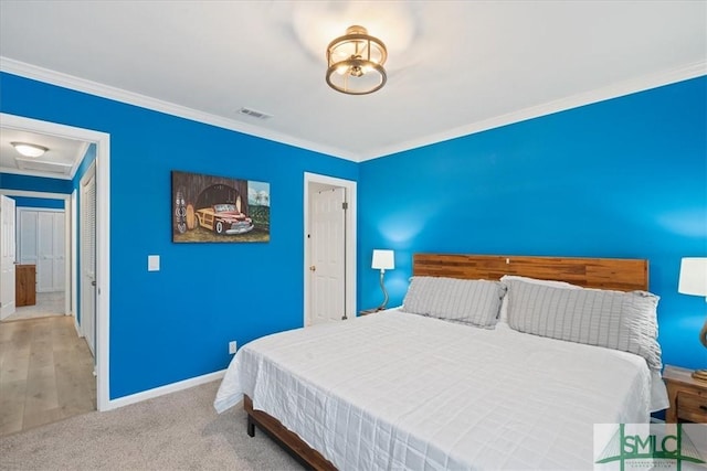 bedroom featuring light carpet, baseboards, visible vents, and ornamental molding