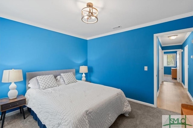 bedroom with visible vents, baseboards, crown molding, carpet floors, and a chandelier