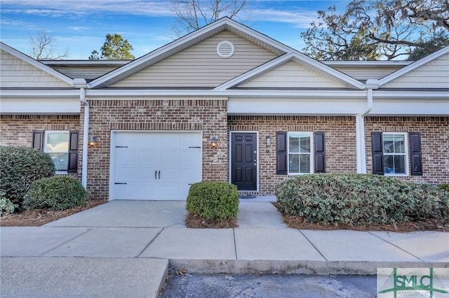 view of front of property featuring concrete driveway, brick siding, and an attached garage