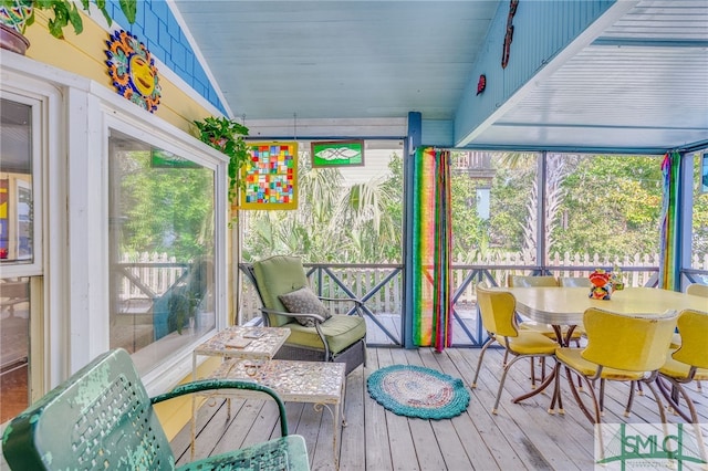 sunroom / solarium featuring lofted ceiling