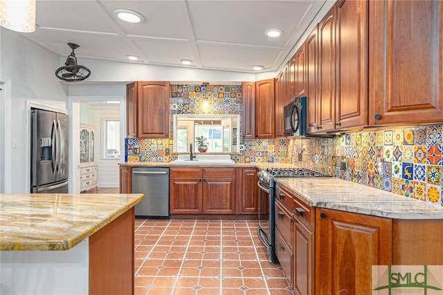 kitchen with recessed lighting, backsplash, appliances with stainless steel finishes, brown cabinetry, and a sink