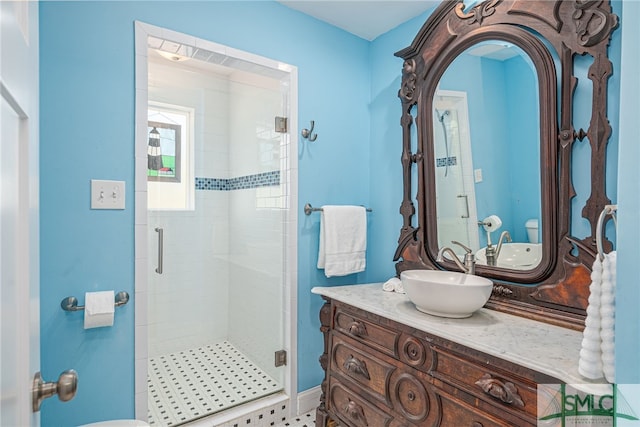 bathroom with a stall shower and vanity