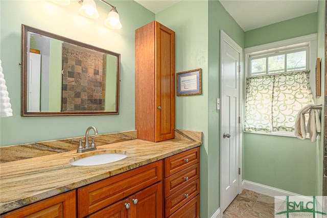 full bathroom with vanity and baseboards