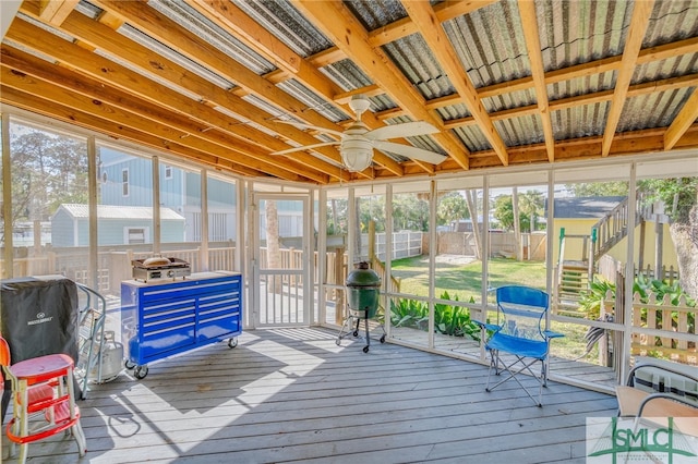 sunroom / solarium featuring a ceiling fan