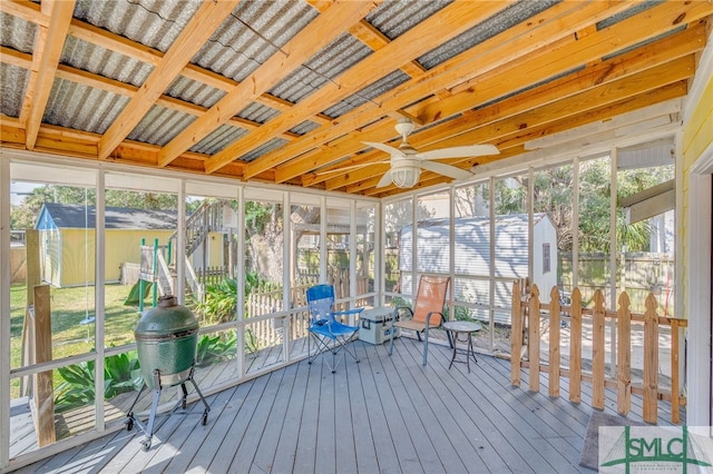 unfurnished sunroom featuring a healthy amount of sunlight and a ceiling fan