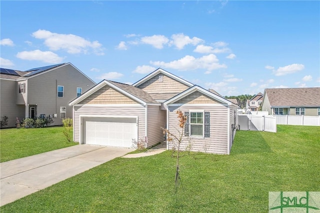 view of front facade with a garage, fence, driveway, a residential view, and a front lawn