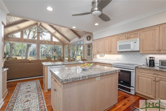 kitchen with a center island, light brown cabinetry, a ceiling fan, white appliances, and a peninsula