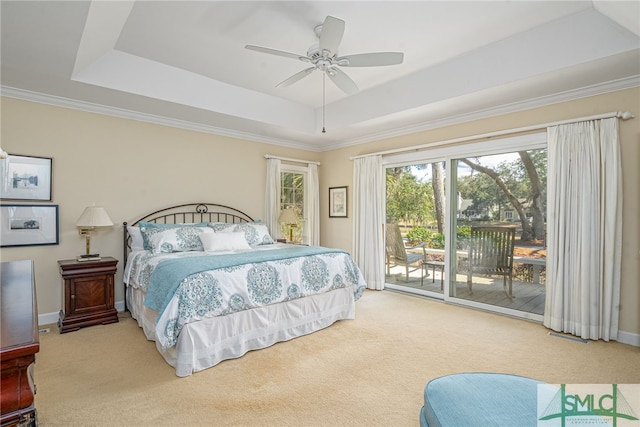 carpeted bedroom featuring access to outside, a tray ceiling, ceiling fan, and baseboards