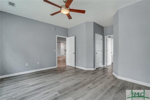 unfurnished bedroom with baseboards, visible vents, and light wood-style floors