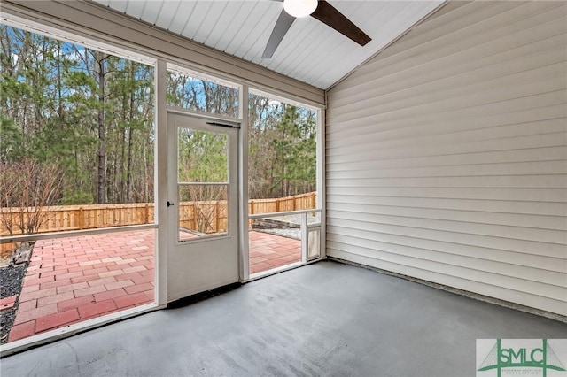 unfurnished sunroom with lofted ceiling and a ceiling fan