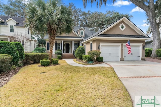 view of front of home with driveway, a garage, metal roof, a standing seam roof, and a front yard