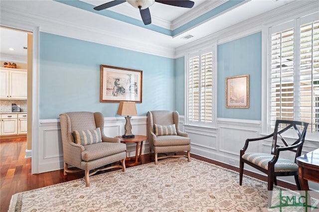 sitting room featuring a wealth of natural light, visible vents, crown molding, and wood finished floors