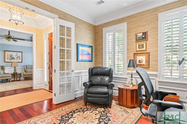 office space with visible vents, wainscoting, ceiling fan, ornamental molding, and wood finished floors