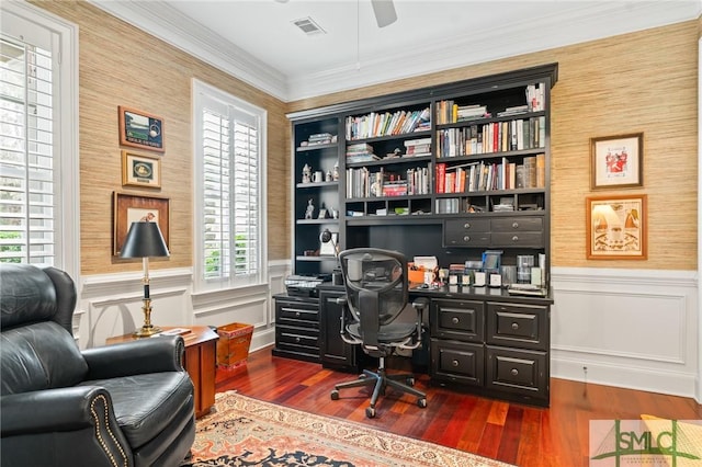 office space with wallpapered walls, crown molding, dark wood-style flooring, and wainscoting