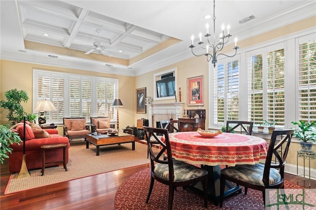 dining room featuring a fireplace, wood finished floors, coffered ceiling, visible vents, and crown molding