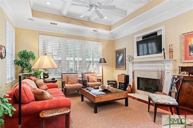 living area with coffered ceiling, a ceiling fan, ornamental molding, beam ceiling, and a high end fireplace