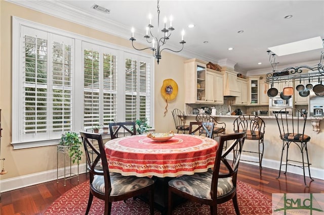 dining space with dark wood-style flooring, crown molding, recessed lighting, visible vents, and an inviting chandelier