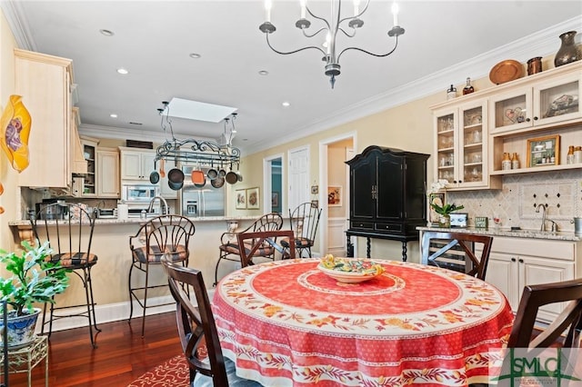 dining area with dark wood-style floors, recessed lighting, a notable chandelier, and crown molding