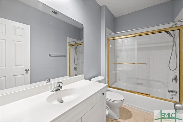 full bath featuring shower / bath combination with glass door, visible vents, toilet, vanity, and tile patterned floors