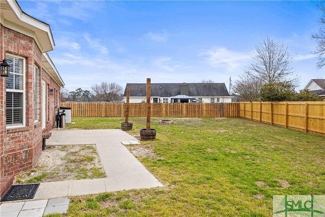 view of yard with a fenced backyard and a patio