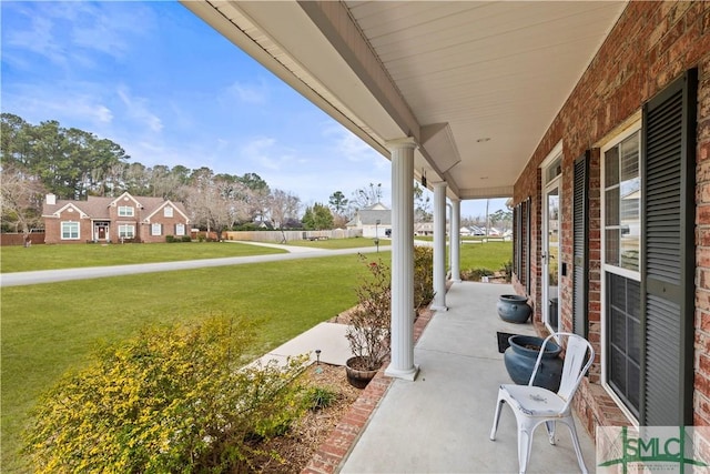 view of patio / terrace with a porch and a residential view