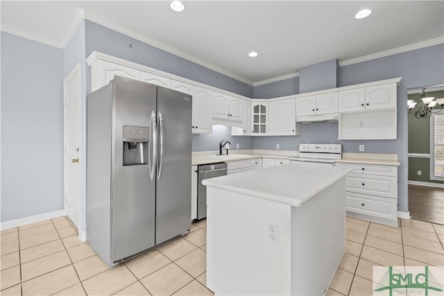 kitchen featuring white cabinets, glass insert cabinets, a center island, stainless steel appliances, and light countertops