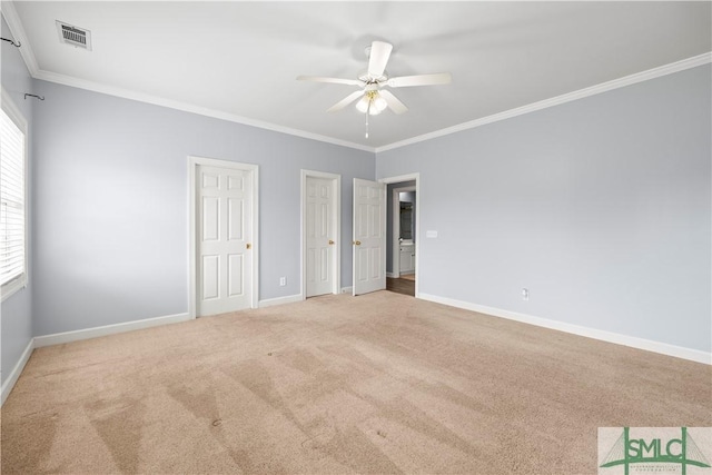 unfurnished bedroom with crown molding, multiple closets, visible vents, light carpet, and baseboards