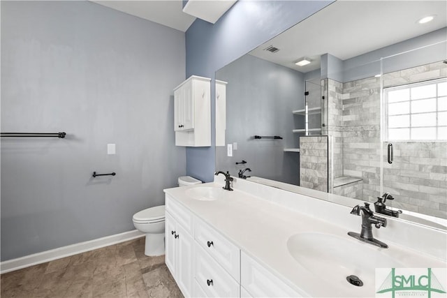 bathroom with visible vents, a sink, toilet, and baseboards