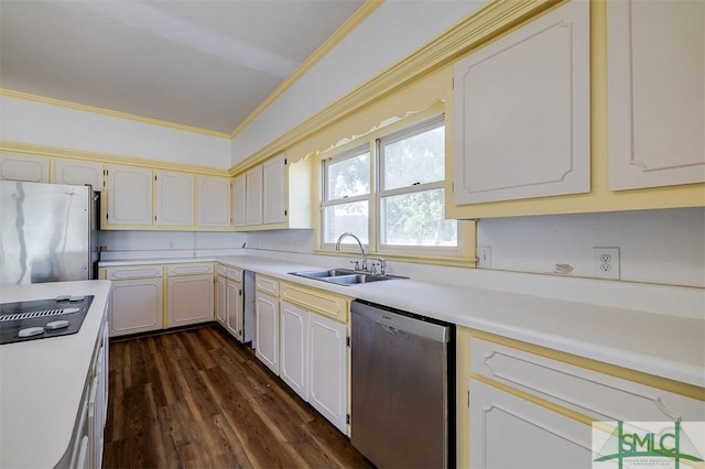 kitchen with white cabinets, ornamental molding, stainless steel appliances, light countertops, and a sink