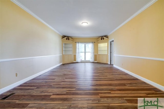 unfurnished room featuring ornamental molding, dark wood-style flooring, and baseboards