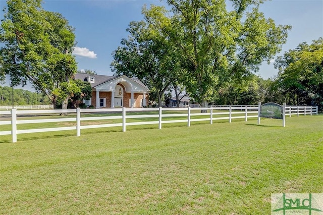 view of yard featuring a rural view and fence