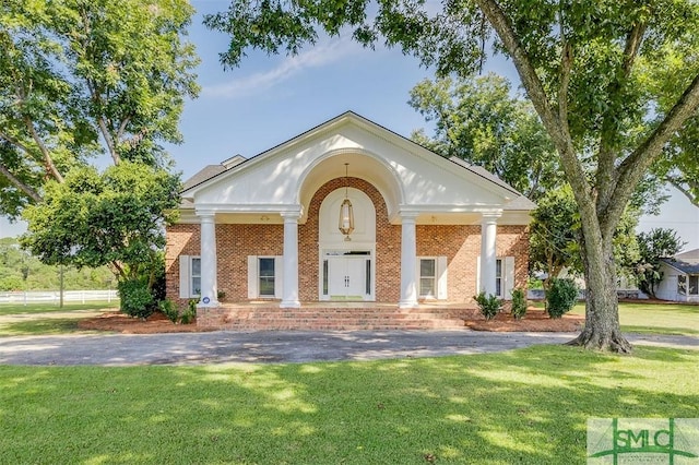 exterior space with a front yard and brick siding