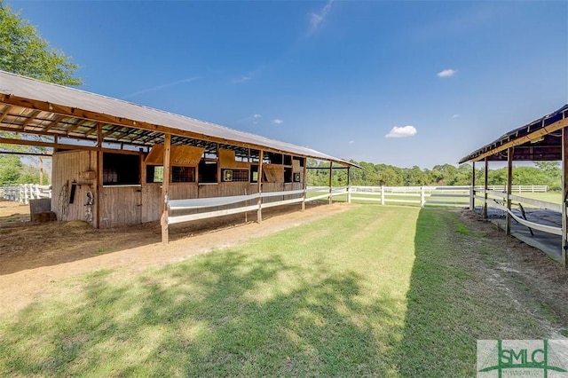 view of horse barn featuring a rural view